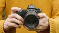 Hands holding the Nikon Z7 II with its Z 85mm f/1.8 lens.