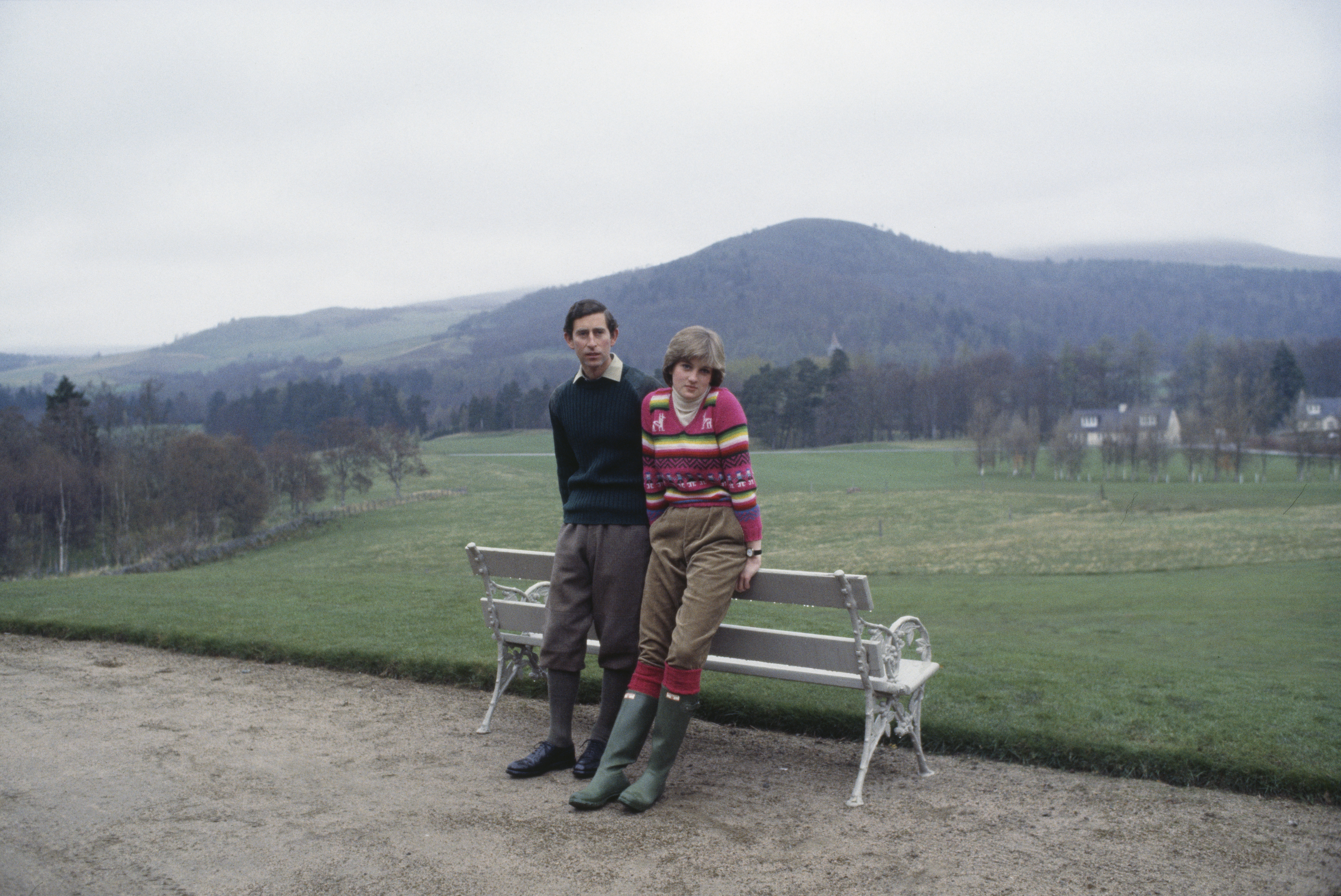 Prince Charles and Lady Diana Spencer pose against a white bench before their wedding