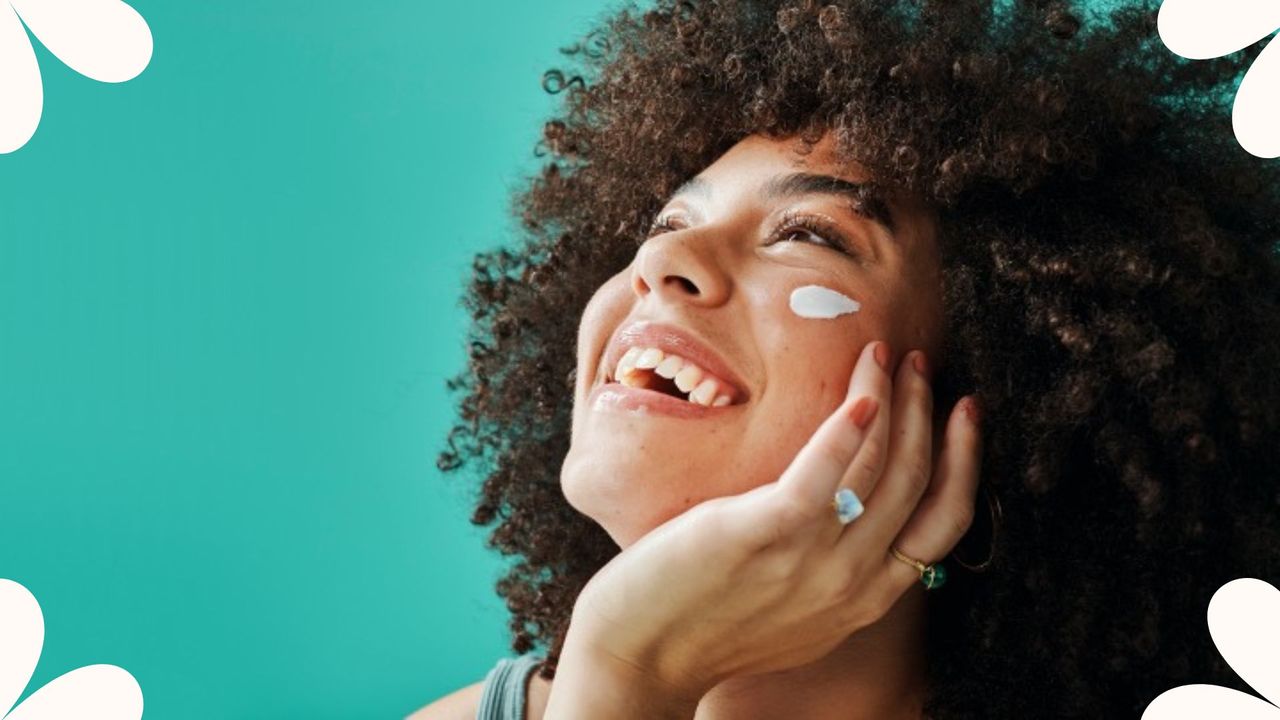 woman applying an spf eye cream against blue background