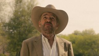 Tommy in cowboy hat looking up in Landman Season 1