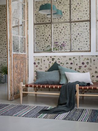 floral wallpaper in hallway with seating area