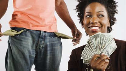 A woman holds a hand full of cash while a man pulls out his empty pocket.