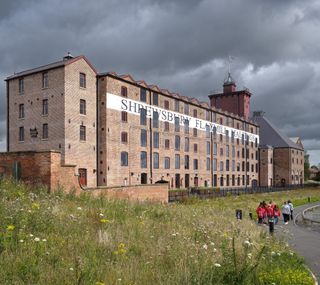 Shrewsbury Flaxmill Maltings exterior showing the renovated historical building with bold font of its name painted on the outside