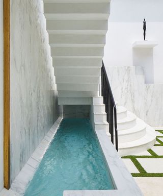 White house wall with stairs and water feature