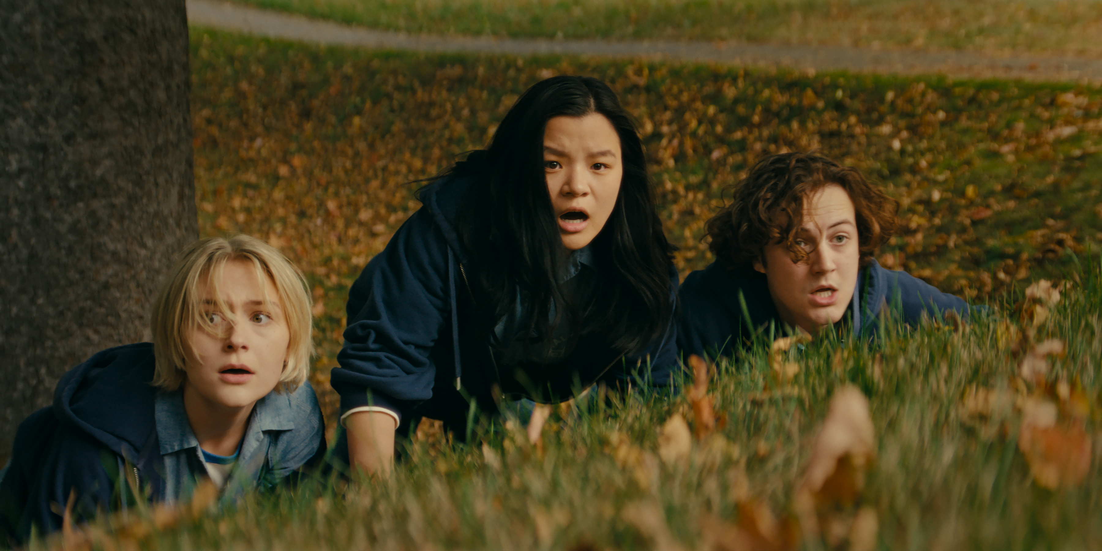 three teenagers hiding in the grass while trying to run away in wayward
