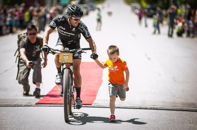 A father and son crossing the finishline together.