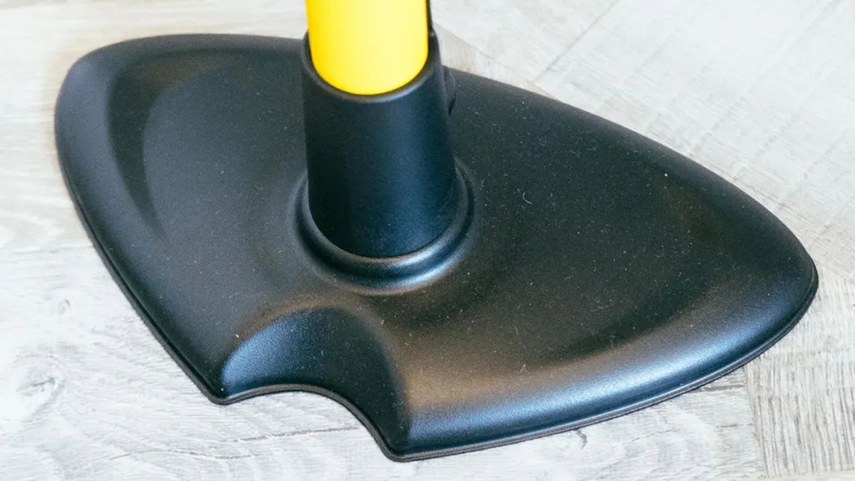 The large base of a yellow floor pump