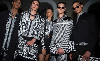 Male models wearing black and white clothes from the Versace S/s 2018 collection