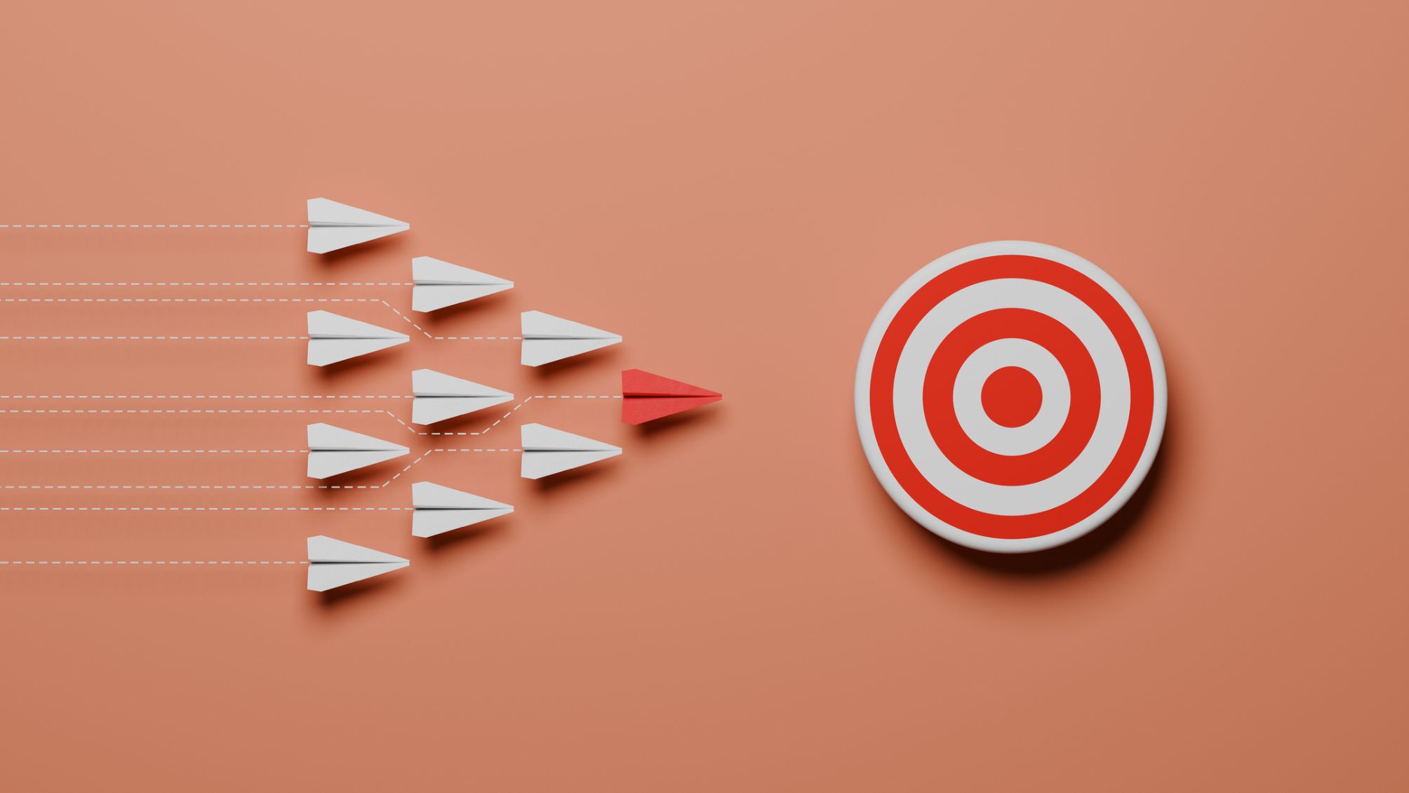 Conceptual image of a group of white paper airplane and a red leader with a trail towards a target