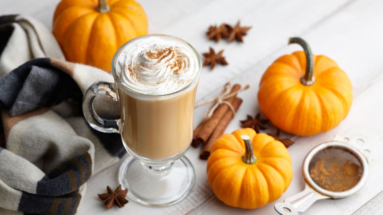 Pumpkin spice latte with decorative pumpkins