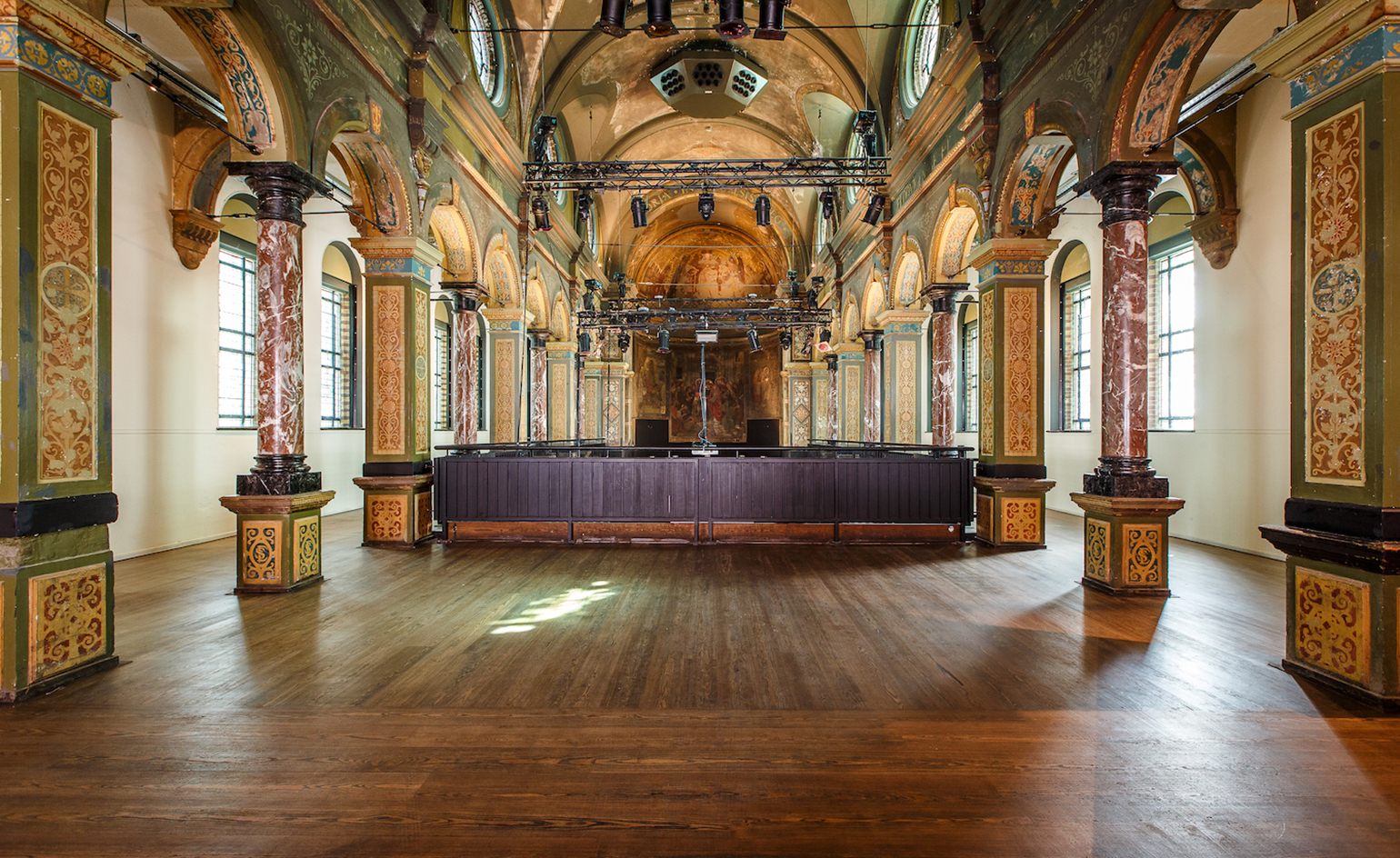 The restored chapel, featuring decorated pillars, domed ceilings and dark wood floor