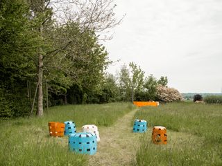 Orange and turquoise baskets shown in a garden