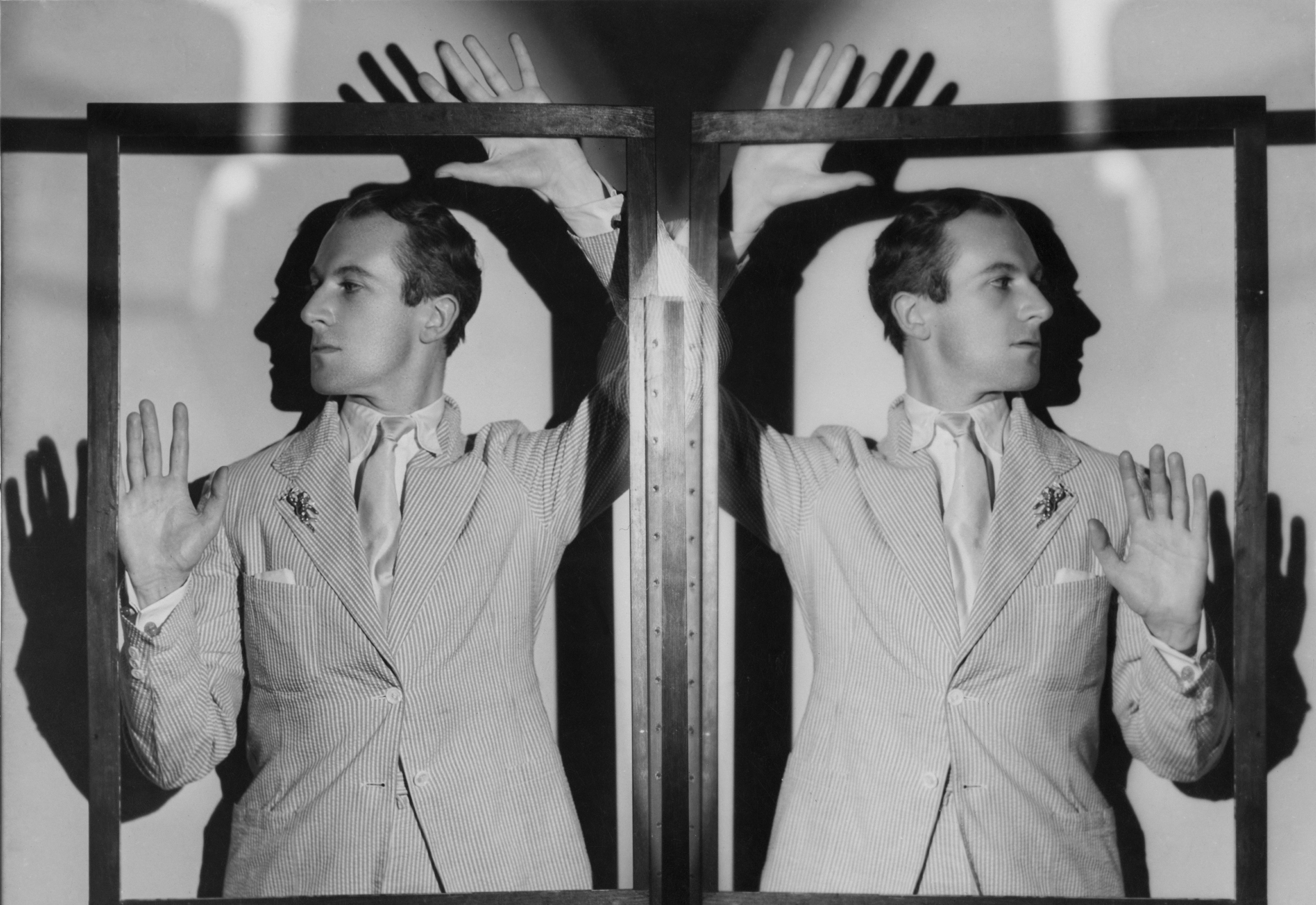 Cecil Beaton and his reflection, circa 1930, poses with his hands raised