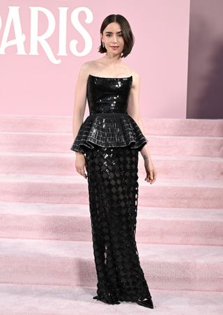 Lily Collins attends the Premiere of Netflix's "Emily in Paris" Season 4 Part 1 at The Egyptian Theatre Hollywood on August 14, 2024 in Los Angeles, California wearing a custom Armani Privé look that included a black, sparkling peplum corset dress, Cartier jewelry, and Manolo Blahnik pumps