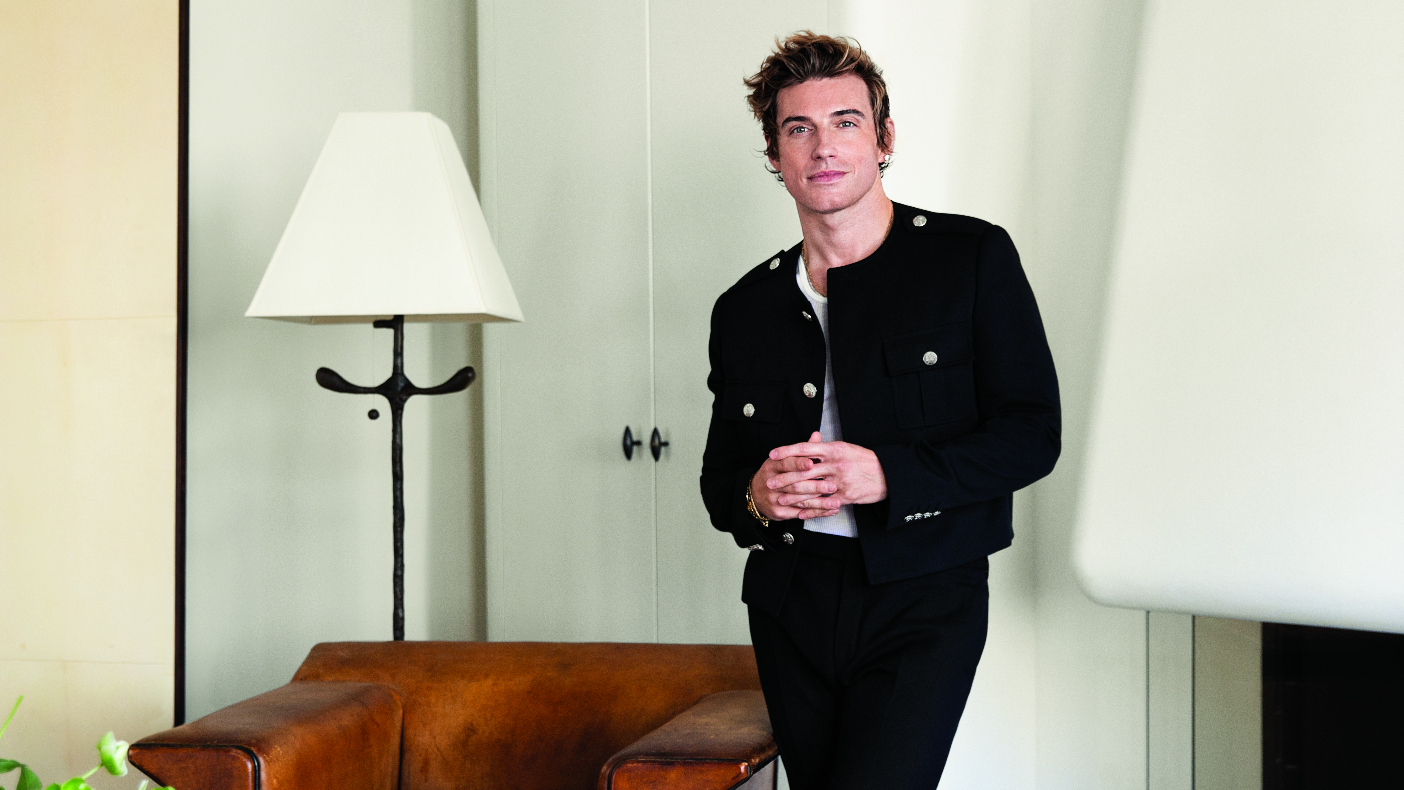 Jeremiah Brent standing in a white room wearing a black jacket