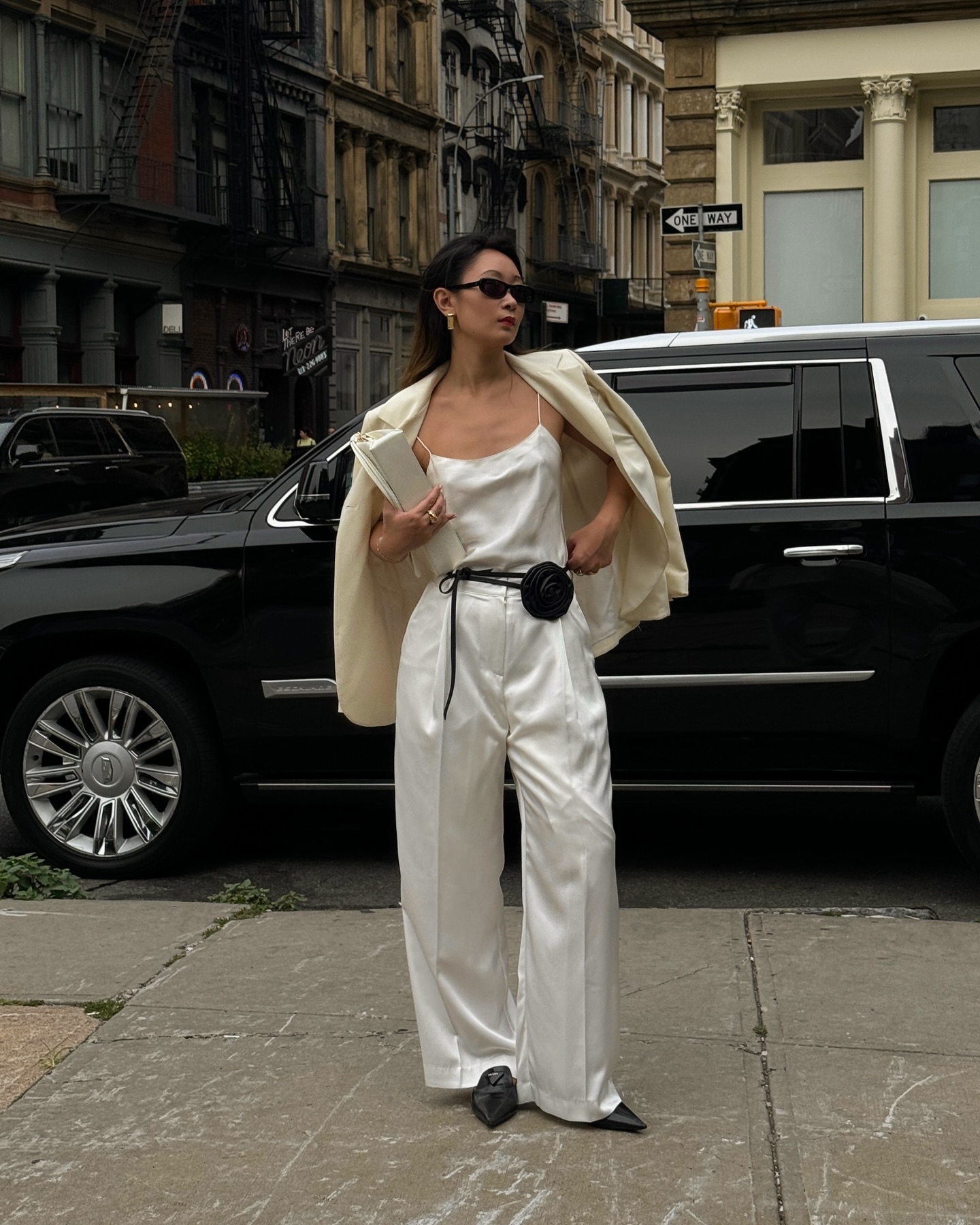 An image of @thecarolinelin wearing silk trousers.