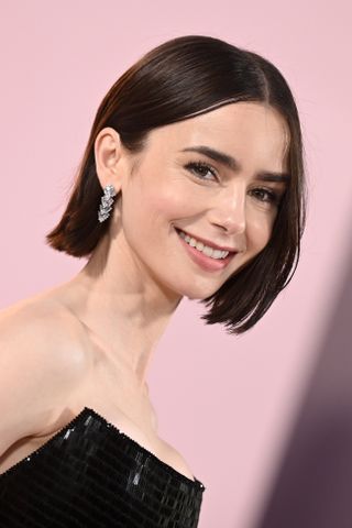 Lily Collins is seen with a short blunt bob at the "Emily in Paris" Season 4, Part 1 Premiere held at The Egyptian Theatre Hollywood on August 14, 2024 in Los Angeles, California.