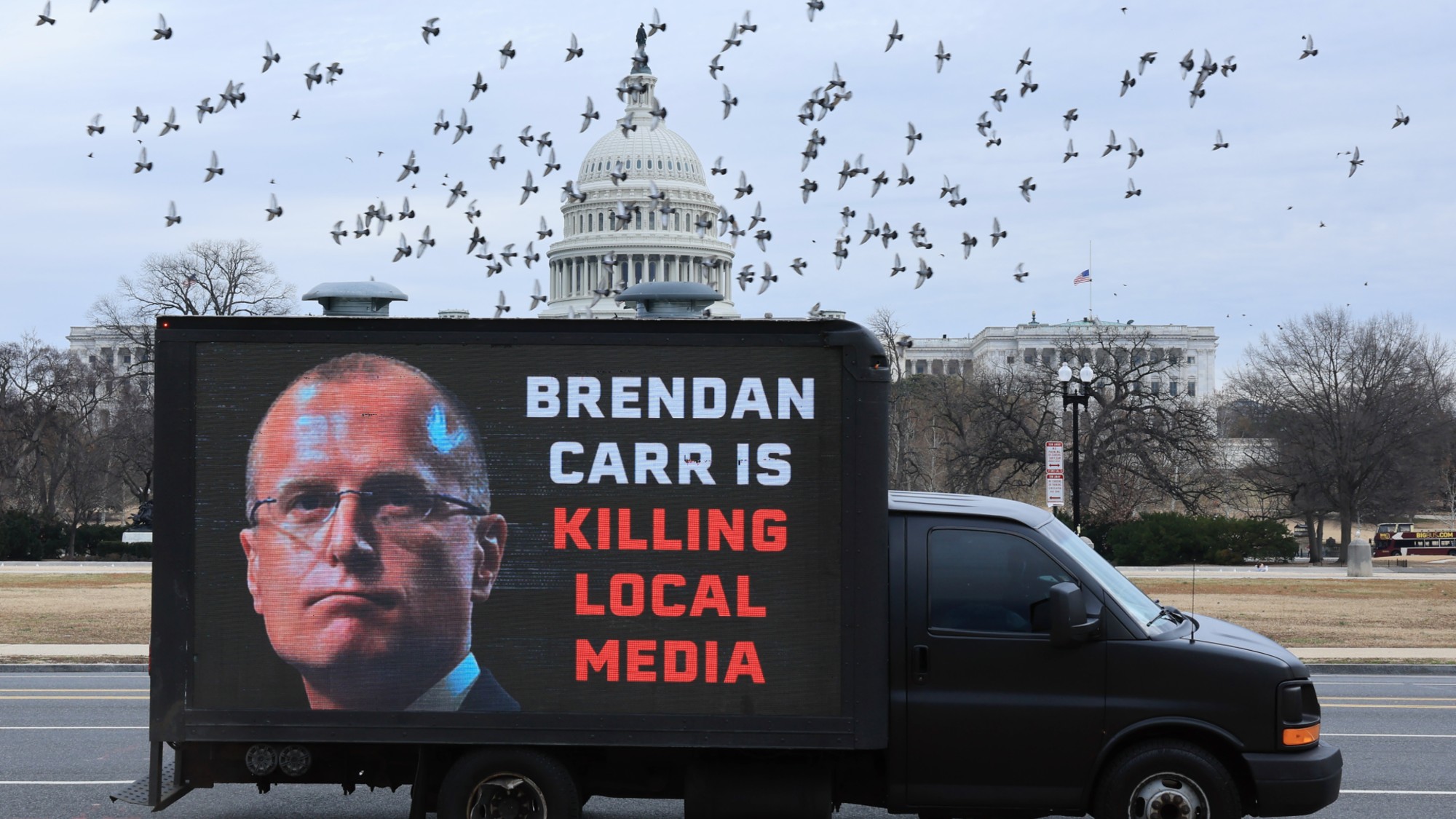 WASHINGTON, DC - JANUARY 14: An electronic billboard calling out FCC Chairman Brendan Carr can be seen in front of the US Capitol on January 14, 2026 in Washington, DC. 