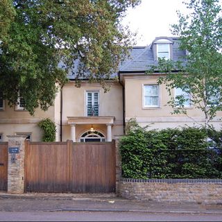 sloping roof house with wooden door and white windows