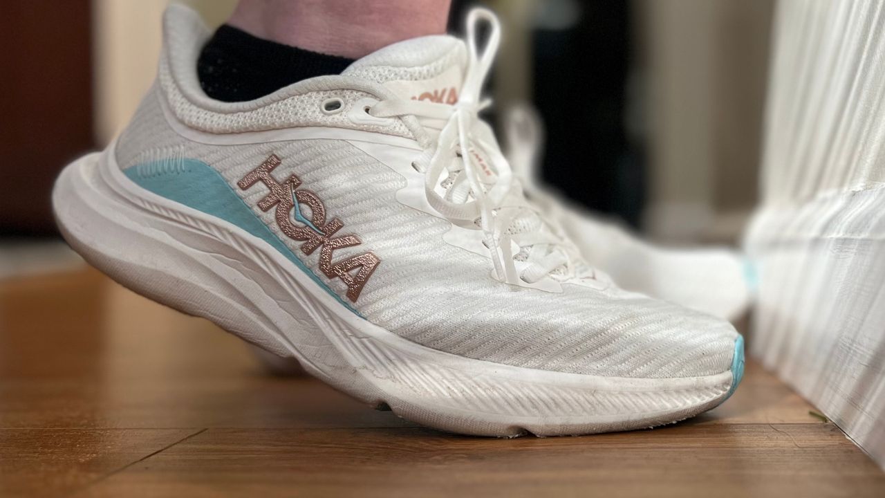 A pair of Hoka Solimar shoes on a wooden floor