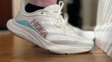 A pair of Hoka Solimar shoes on a wooden floor