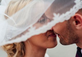 Wedding readings: a couple kiss on their wedding day
