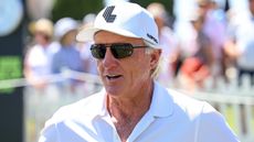 Greg Norman wearing a white shirt and cap during a LIV Golf event