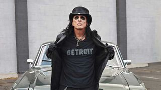 Alice Cooper leaning on a car wearing a 'Detroit' t-shirt