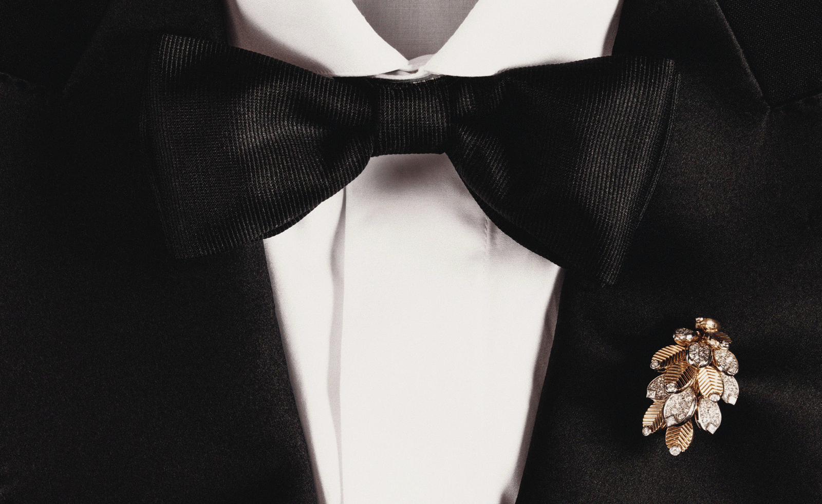 cartier brooch on black tie