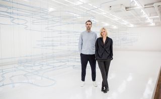 Karin Gustafsson of COS and Snarkitecture's Alex Mustonen standing next to each other in front of their display.