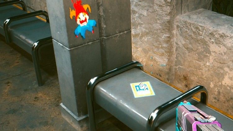 Screenshot from Cyberpunk 2077 showing a Balatro 'Jimbo' Jester graffiti on a bus stop