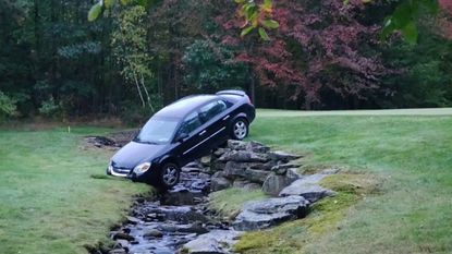 A car crashed into a golf course creek
