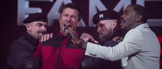 Glen Powell as Ben Richards yells into a microphone in The Running Man