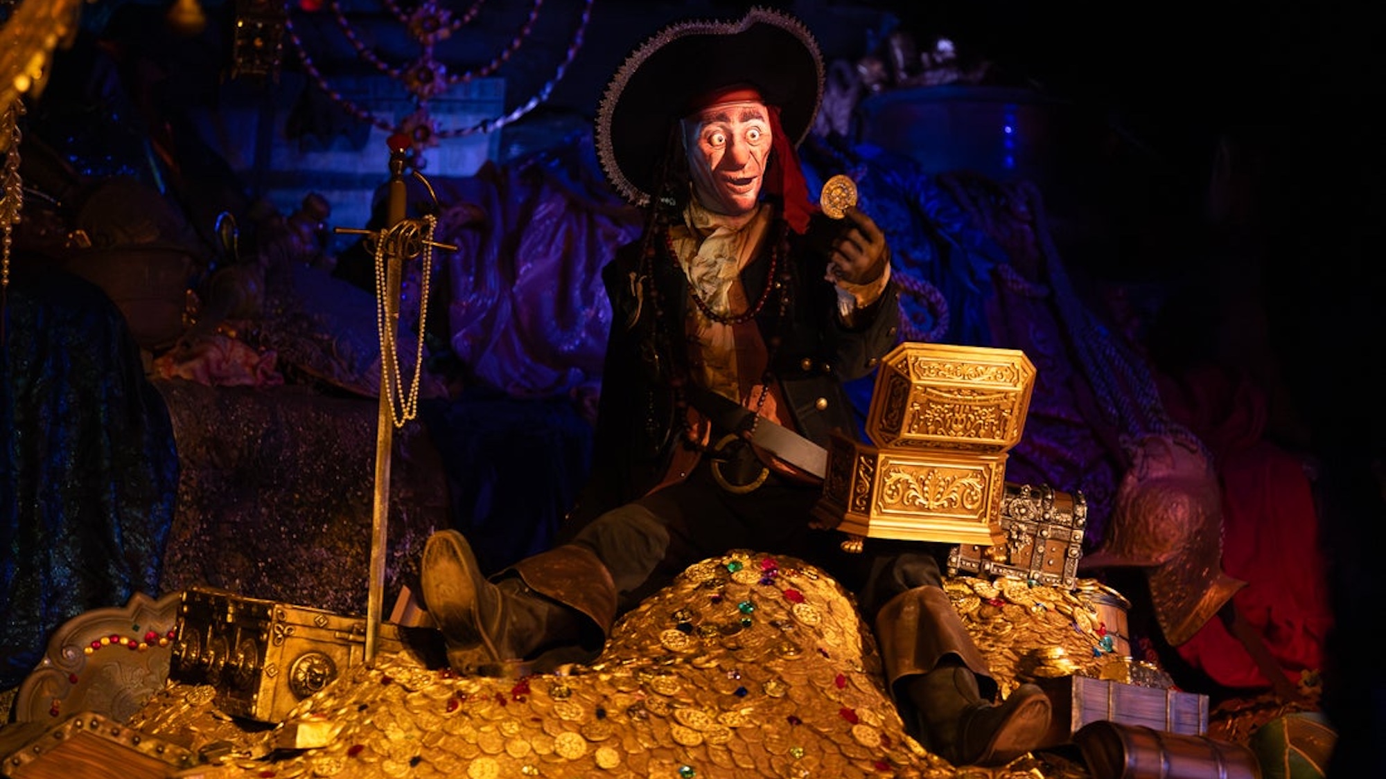 Pirates of the Caribbean at Disneyland Park June 2026 change features a pirate sitting atop a pile of cursed gold that can transform from a flesh-and-blood buccaneer to a skeleton.