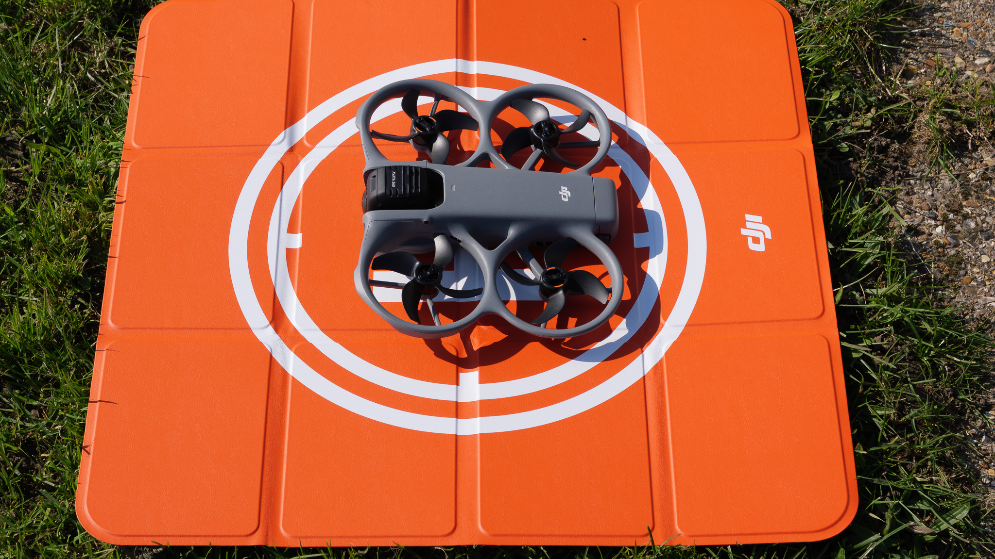 DJI Avata 360 drone on bright orange landing pad