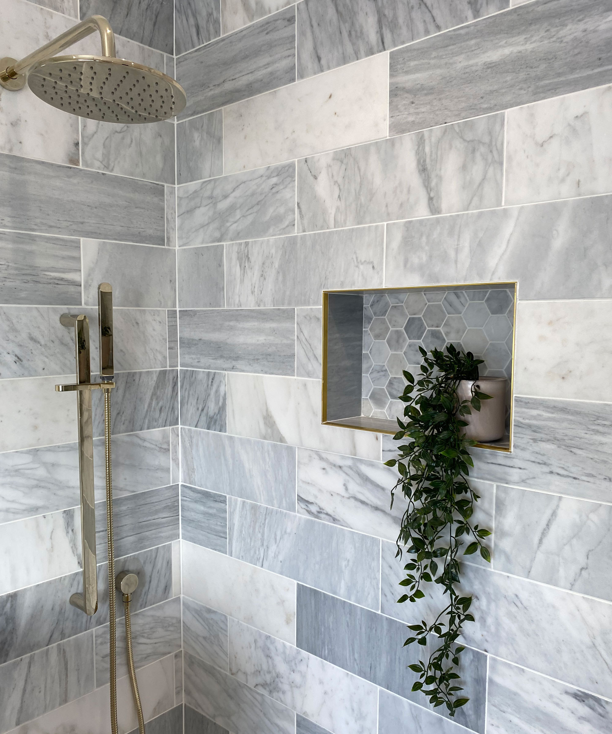 shower with storage and grey tiles