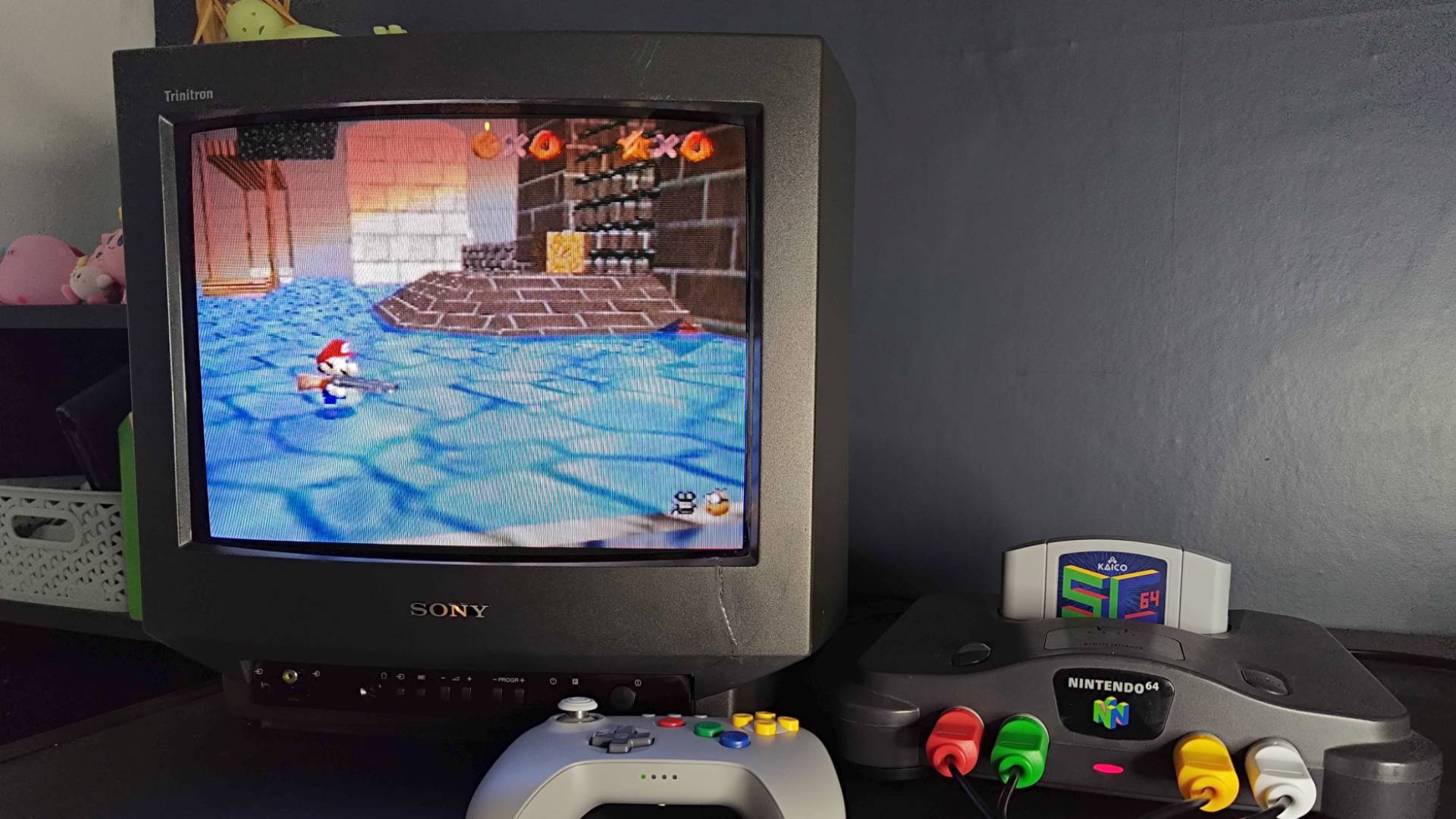 Photo of N64 connected to Sony Trinitron CRT TV running Super Mario 64 Shotgun mod via Summercart64.