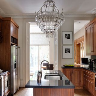 kitchen area with wooden units and chandelier