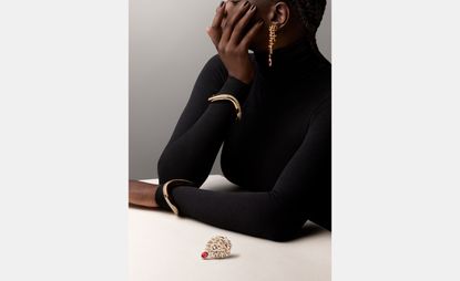 woman wearing gold bracelets and earring by Chanel and Pomellato