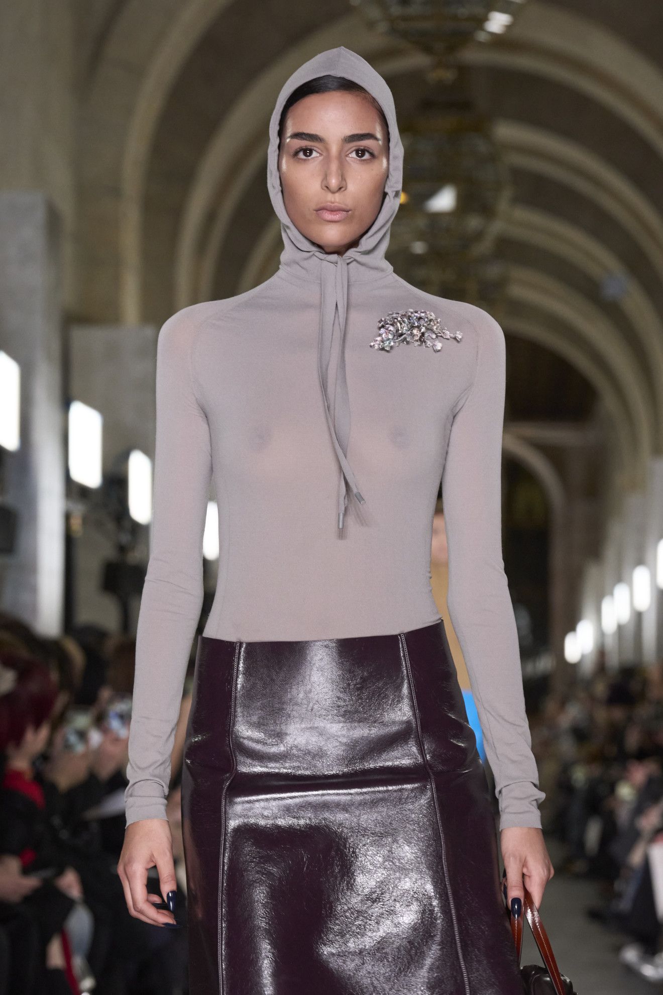 models wearing brooches on the runway