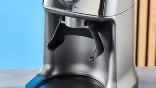 the breville dose control pro, called sage dose control pro in the uk, a silver coffee grinder with 60 grind settings and labeled grind size adjustment