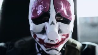 A close-up of a live-action actor wearing a Payday clown mask.