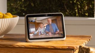 The Facebook Portal Go being used for a video call on a wooden table