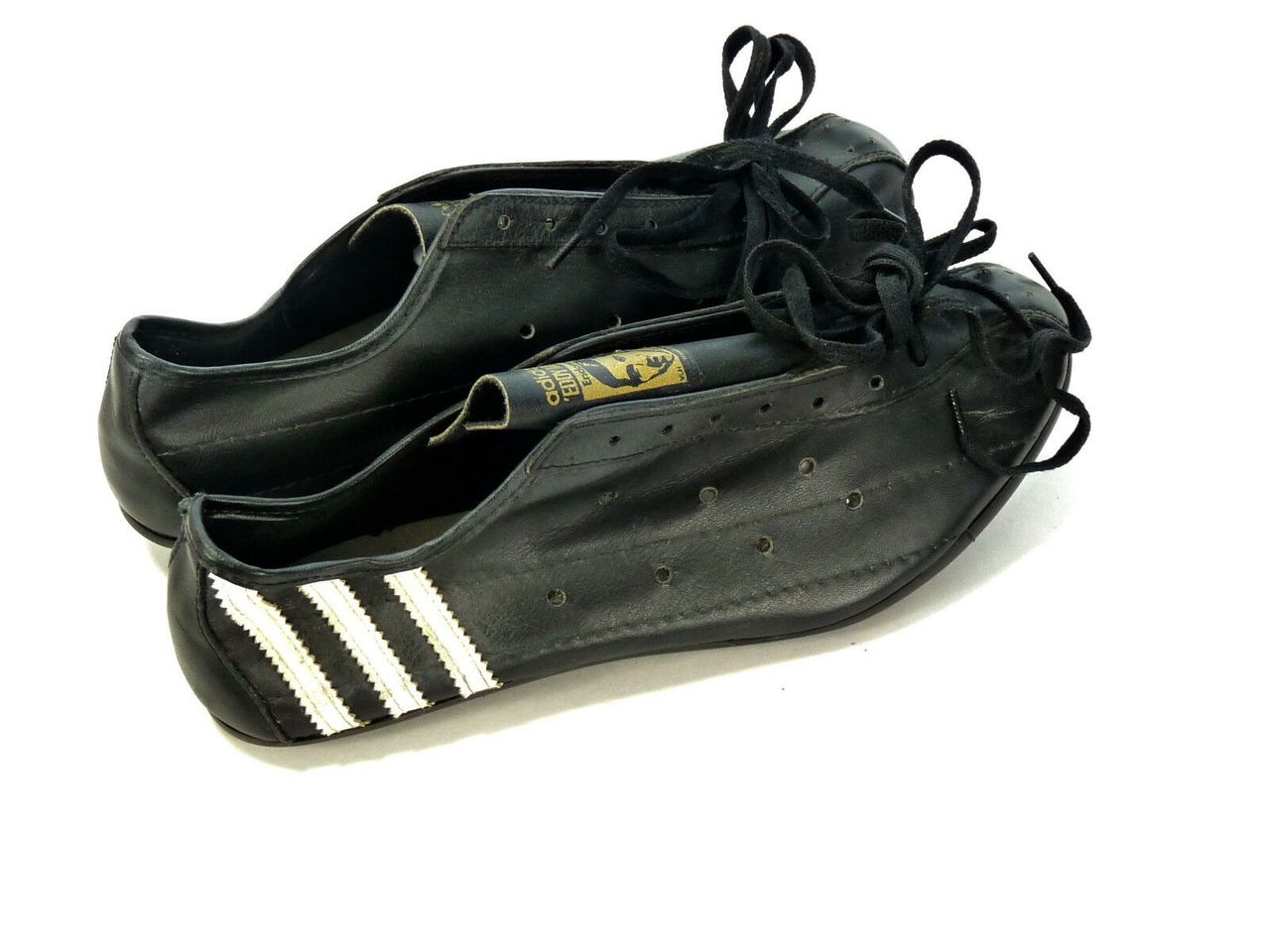 Those iconic three white stripes really stand out on the black leather