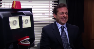Michael Scott laughing in his office.