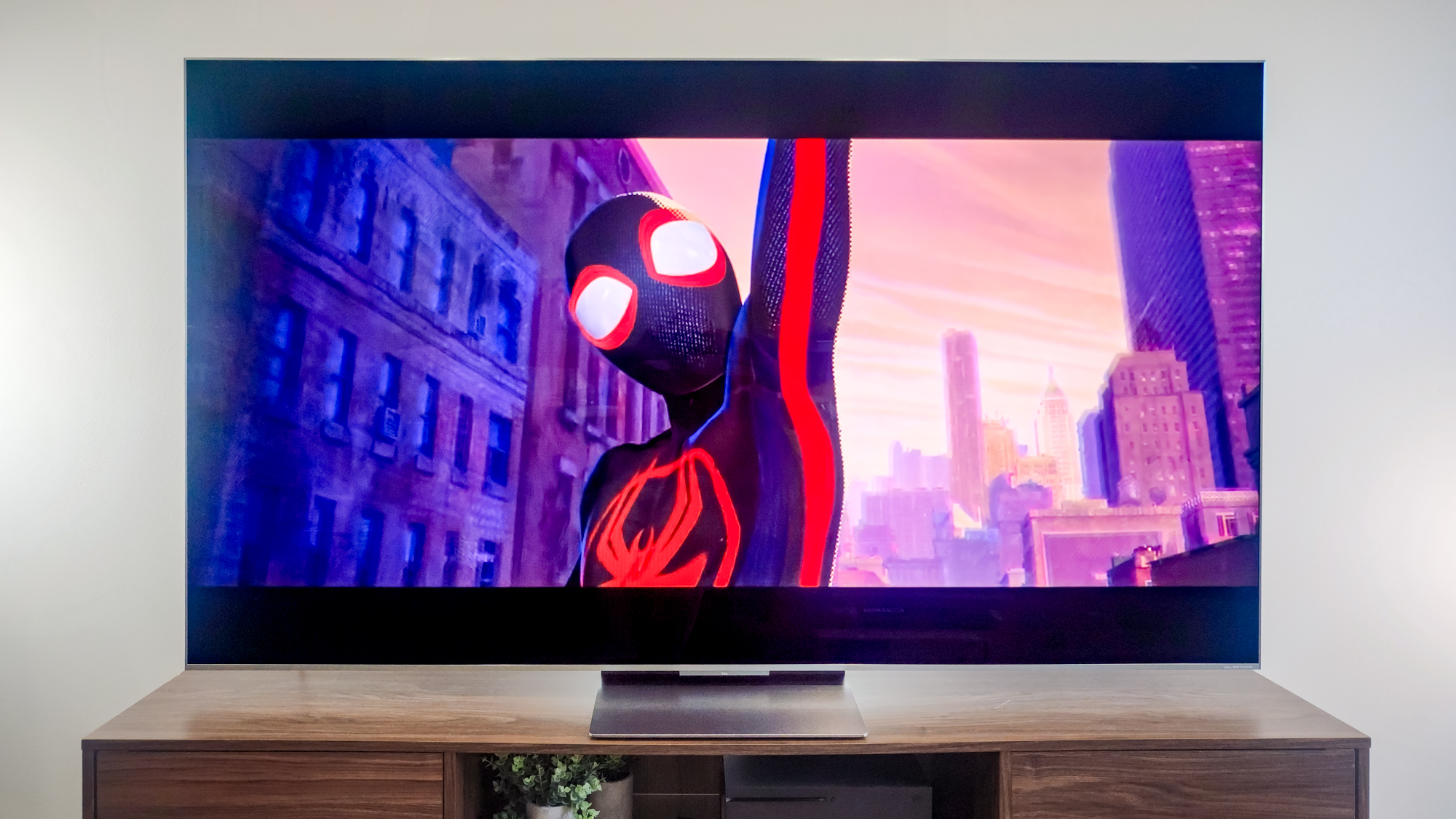 A TCL QM9K TV on a side table