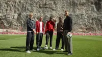 AS Monaco players standing on a pitch with B&O products 