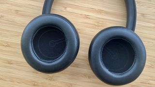 Inner earcups of the Dali IO-8 over-ear headphones on a wood surface