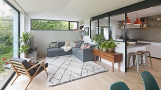 living room with high level windows and internal glass partition