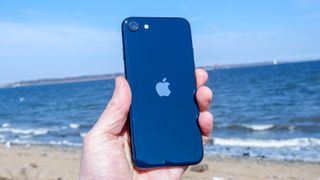 iPhone SE 2022 back of phone in hand at beach